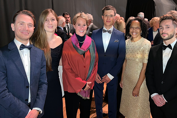 Six people pose for a photo at the 2022 Nobel Ceremony in Stockholm