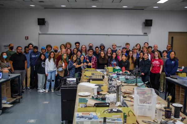 Two studios of PIE classes pose for a large group photo in 2022.