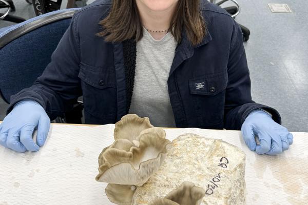 Student Cassandre Roos with class grown mushrooms