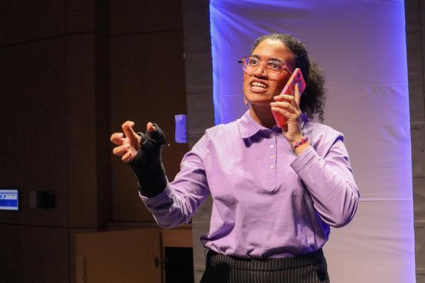 An Olin student holds a telephone to their ear during FWOP's fall performance of "The Guy Who Didn't Like Musicals."