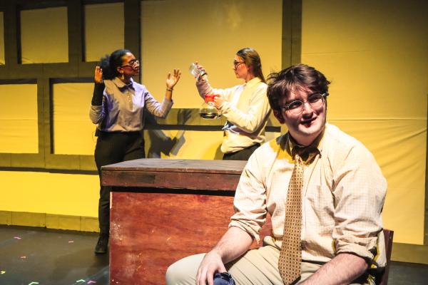 Members of FWOP are shown on stage performing a scene from "The Guy Who Didn't Like Musicals."