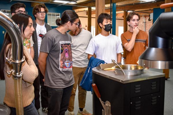 Students stand in front of the air roaster. 