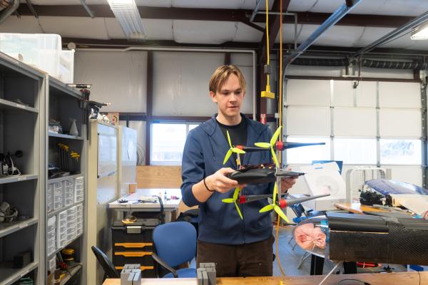 An Olin AERO project team student holds up a project.