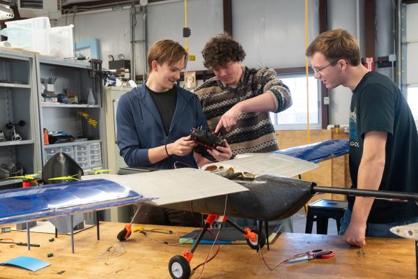 Three Olin AERO project team students work together on their plane.