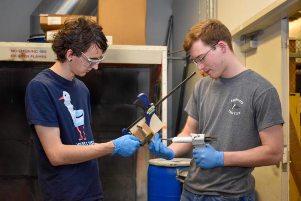 Two Olin AERO project team students work to assemble build components.