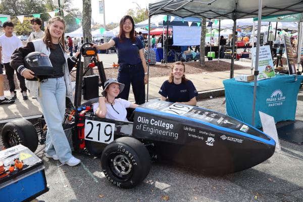 Olin OTEM team members gather around their car. 