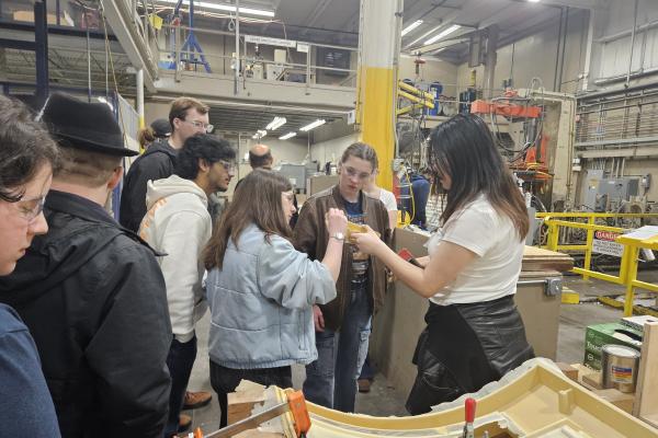 Students and staff learning about Armstrong Mold Corporation.