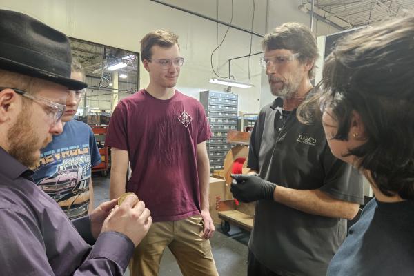 Students speak with a team member from Darco Manufacturing. 