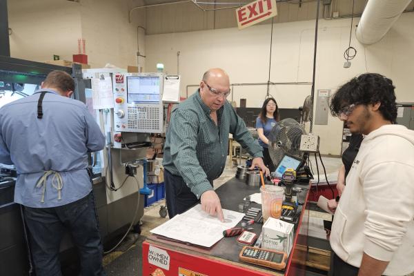 Students observe a part of Instron's manufacturing process. 