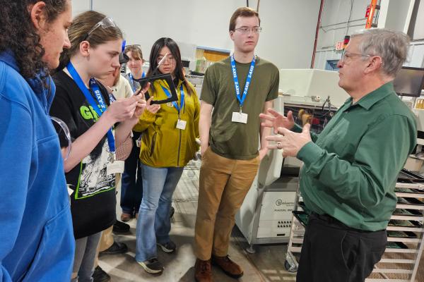 Students listen to a member of the Z-AXIS/Bear Power Supplies team describe their manufacturing process. 