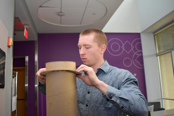A student working with cardboard. 