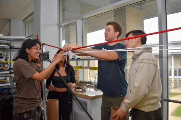 Four students working on their MechProto Build Challenge project. 