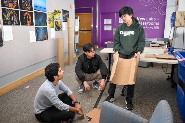 Three students work on their models for MechProto's first Build Challenge. 