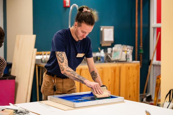 A Makerspace Institute participant screen printing. 