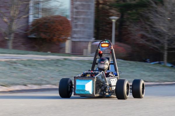 The Olin Electric Motorsports Team's electric car is seen on the road